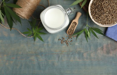 Photo of Flat lay composition with fresh hemp milk on light blue wooden table. Space for text