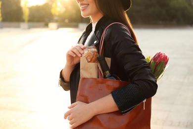 Woman with leather shopper bag on city street, closeup