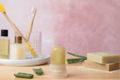 Photo of Natural crystal alum deodorant and aloe on wooden table