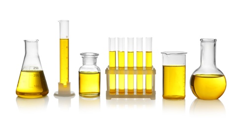 Photo of Laboratory glassware with yellow liquid on white background