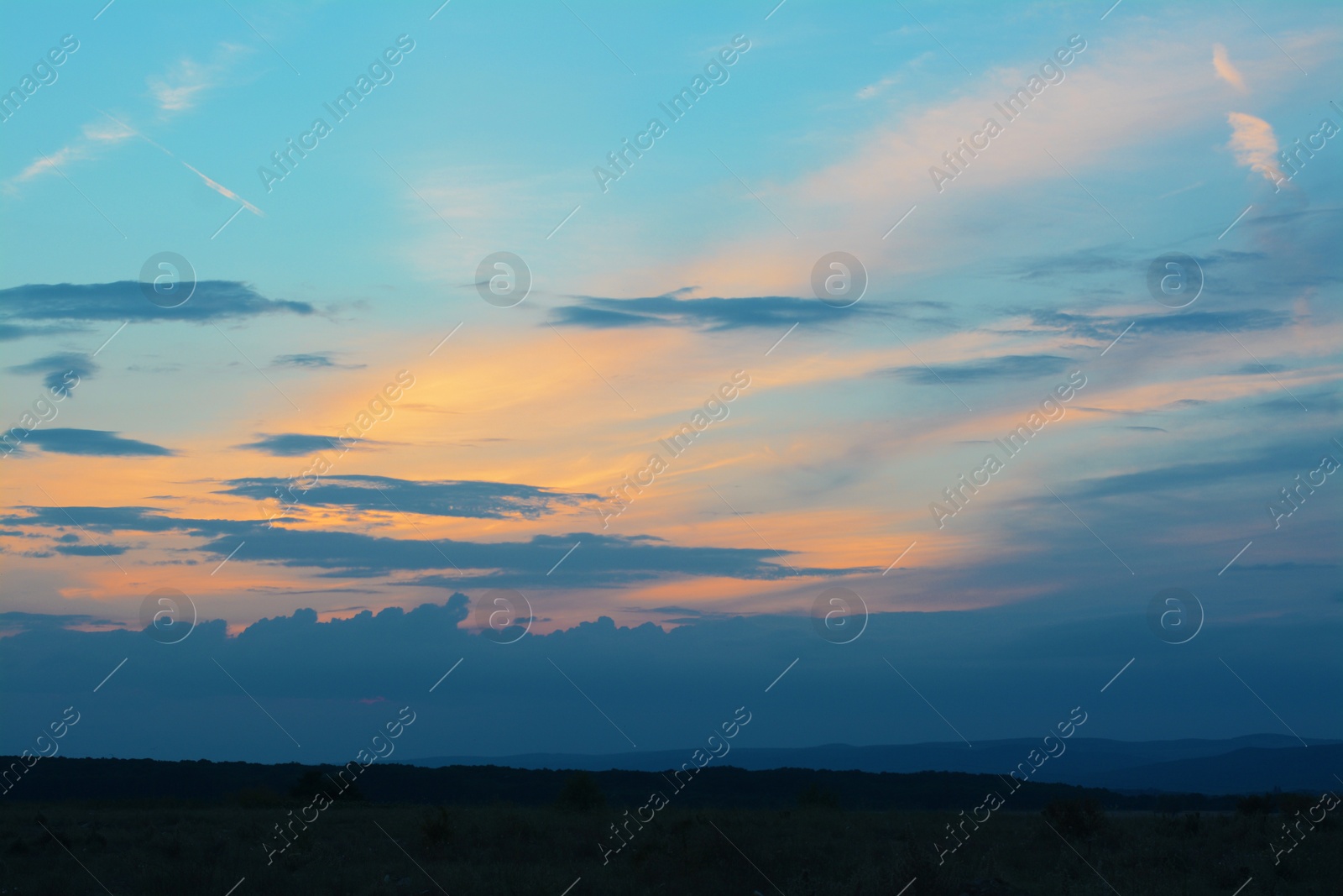 Photo of Beautiful landscape with sky lit by sunset