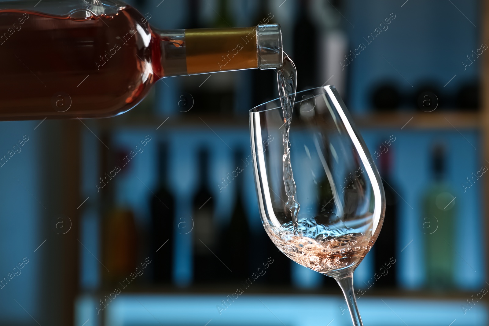 Photo of Pouring wine into glass in restaurant, closeup