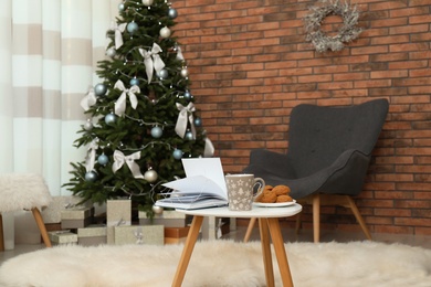 Stylish living room interior with decorated Christmas tree