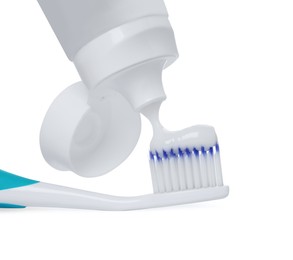 Photo of Applying paste on toothbrush against white background, closeup