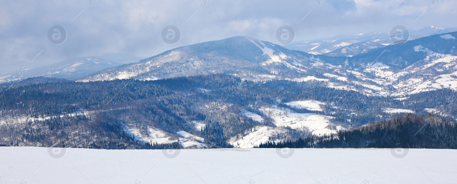 Image of Picturesque view of snowy hills at mountain resort. Banner design