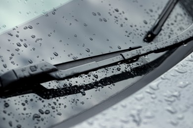Photo of Car wipers and water drops on windshield glass, closeup