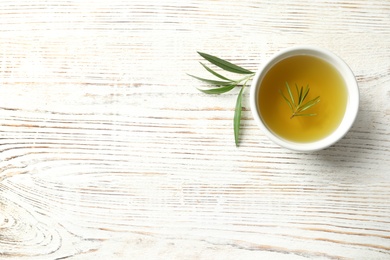 Flat lay composition with fresh olive oil on wooden background