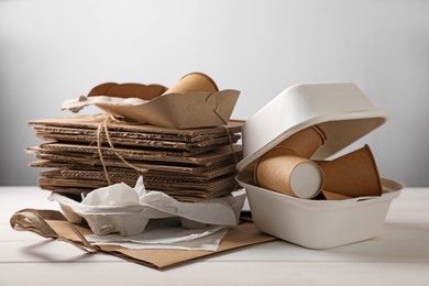 Heap of waste paper on white wooden table