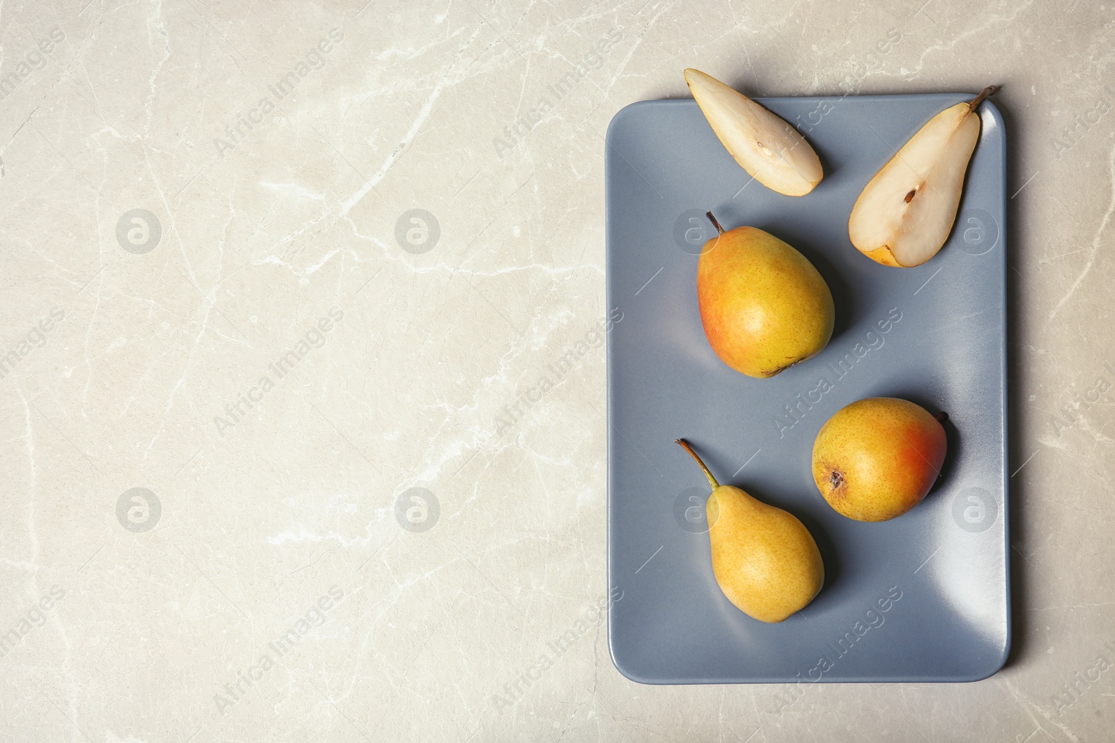 Photo of Flat lay composition with ripe pears on grey background. Space for text