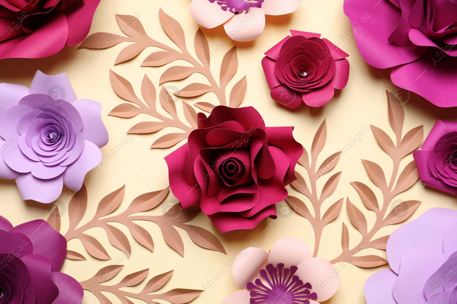 Photo of Different beautiful flowers and branches made of paper on beige background, flat lay