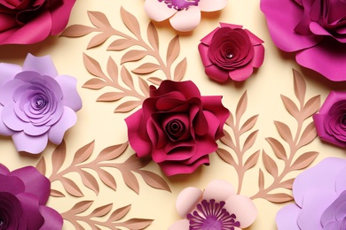 Photo of Different beautiful flowers and branches made of paper on beige background, flat lay