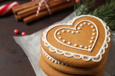 Tasty heart shaped gingerbread cookies on wooden table, closeup