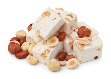 Photo of Pieces of delicious nougat and nuts on white background