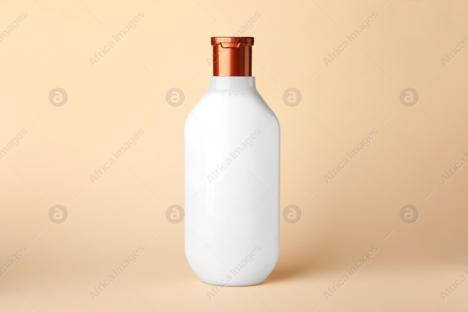 Photo of One bottle of shampoo on beige background