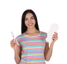 Young woman with menstrual pad and tampon on white background