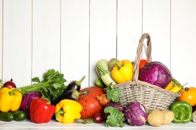 Many fresh ripe vegetables on wooden background. Organic food