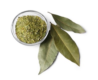 Whole and ground aromatic bay leaves on white background, top view