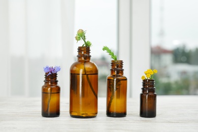 Composition with essential oils and flowers on table