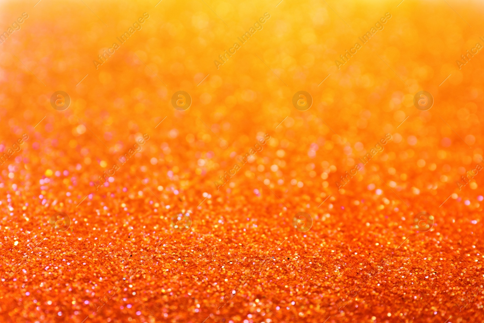 Photo of Shiny orange glitter as background. Bokeh effect