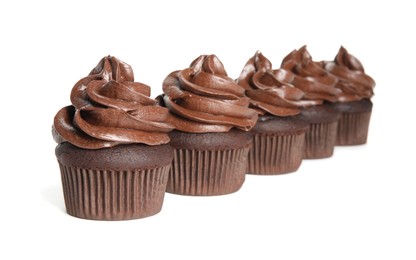 Delicious chocolate cupcakes with cream on white background