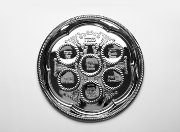 Empty traditional Passover (Pesach) Seder plate on white background, top view