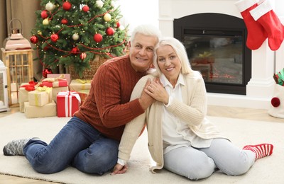 Photo of Happy mature couple at home. Christmas celebration