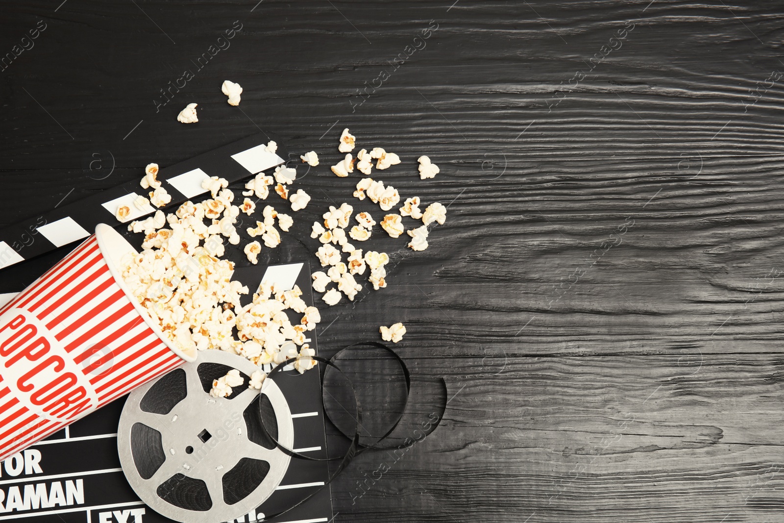 Photo of Flat lay composition with tasty popcorn and space for text on wooden background. Cinema snack