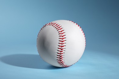 Photo of One baseball ball on light blue background