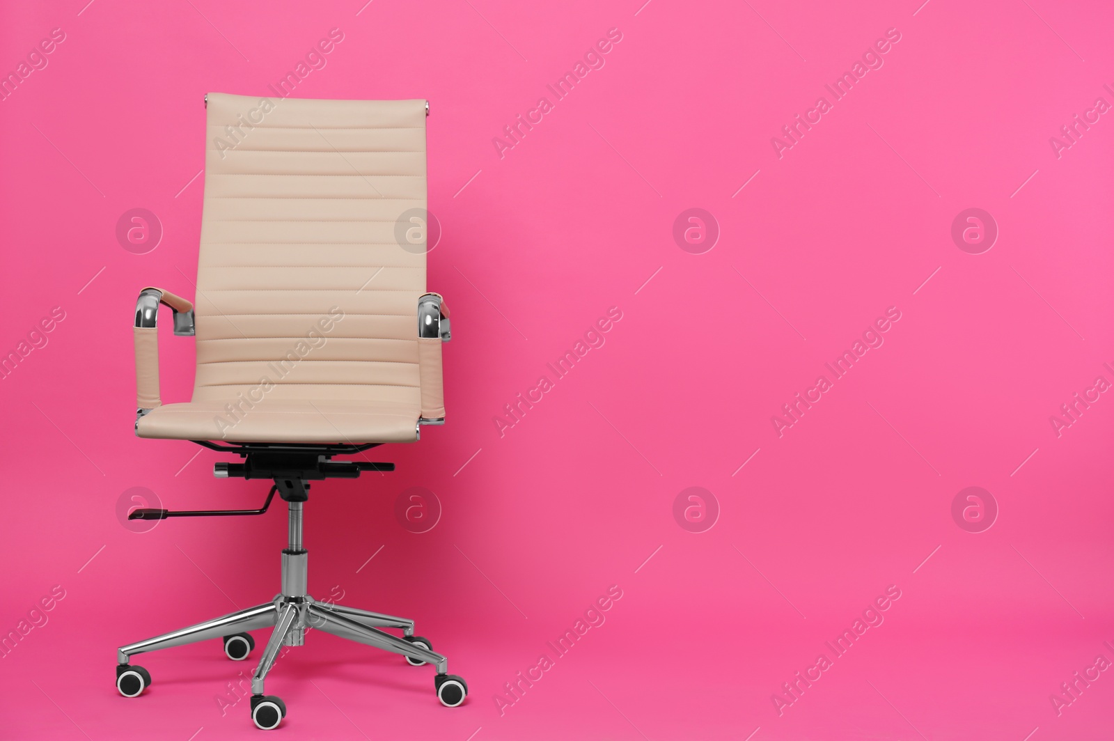 Photo of Comfortable office chair on pink background, space for text