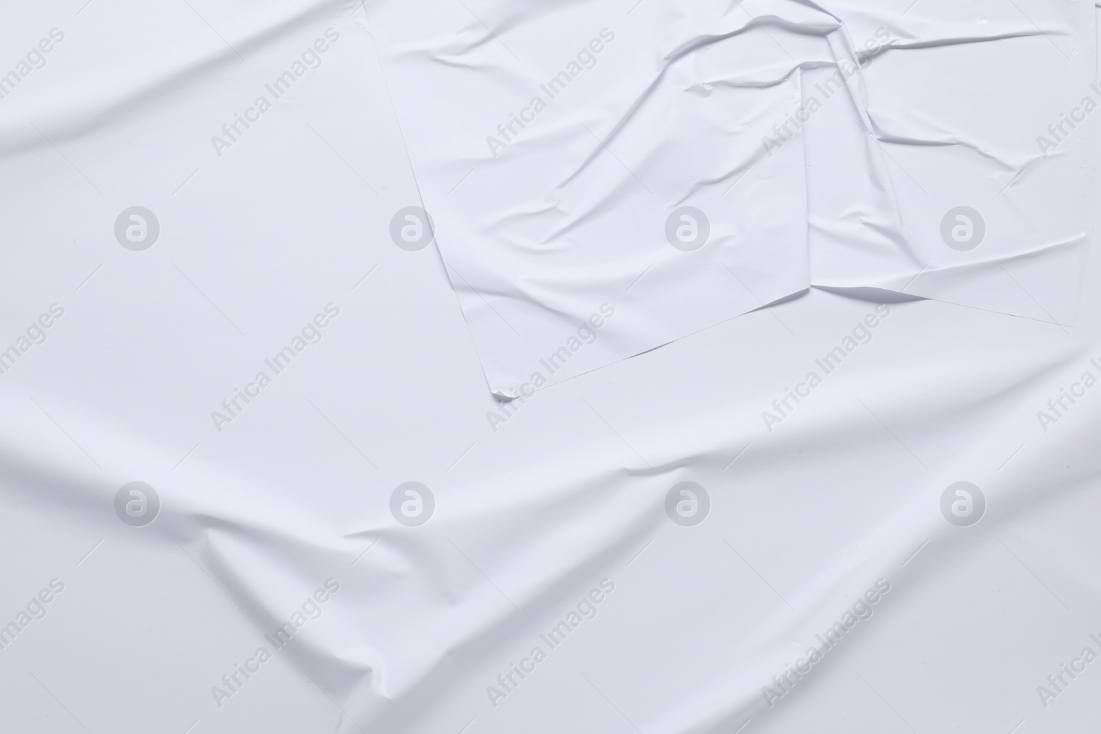 Photo of White crumpled sheet of paper as background, top view. Wall poster