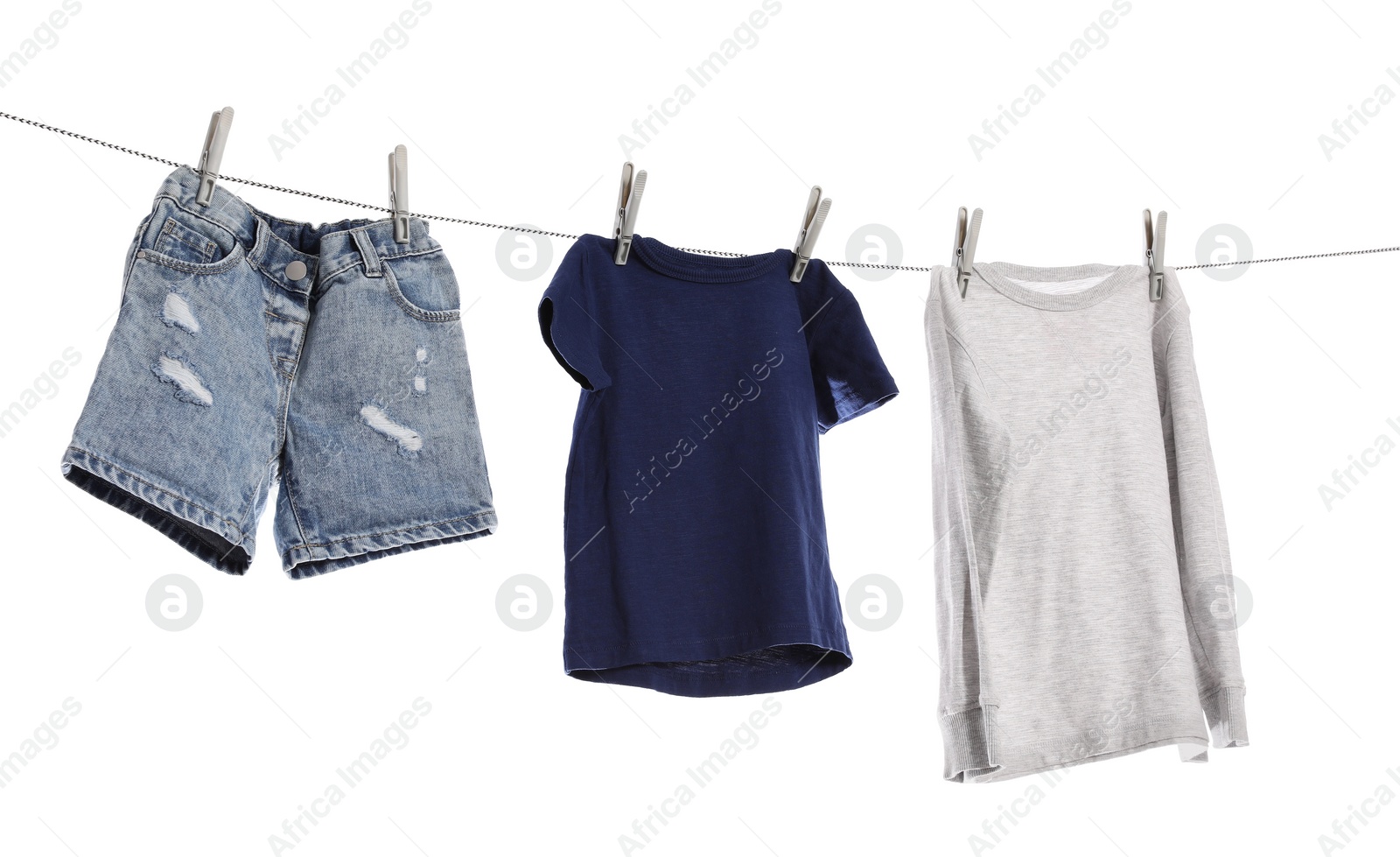 Photo of Different clothes drying on washing line against white background