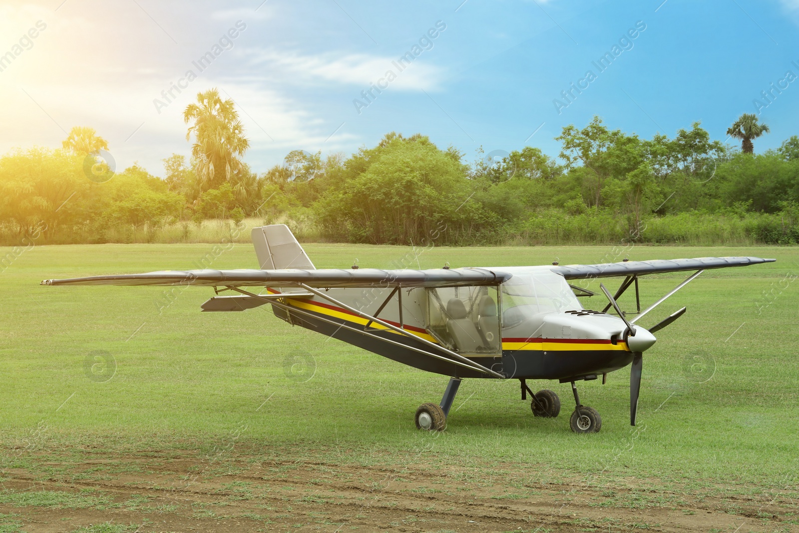 Photo of View of beautiful ultralight airplane in field on autumn day