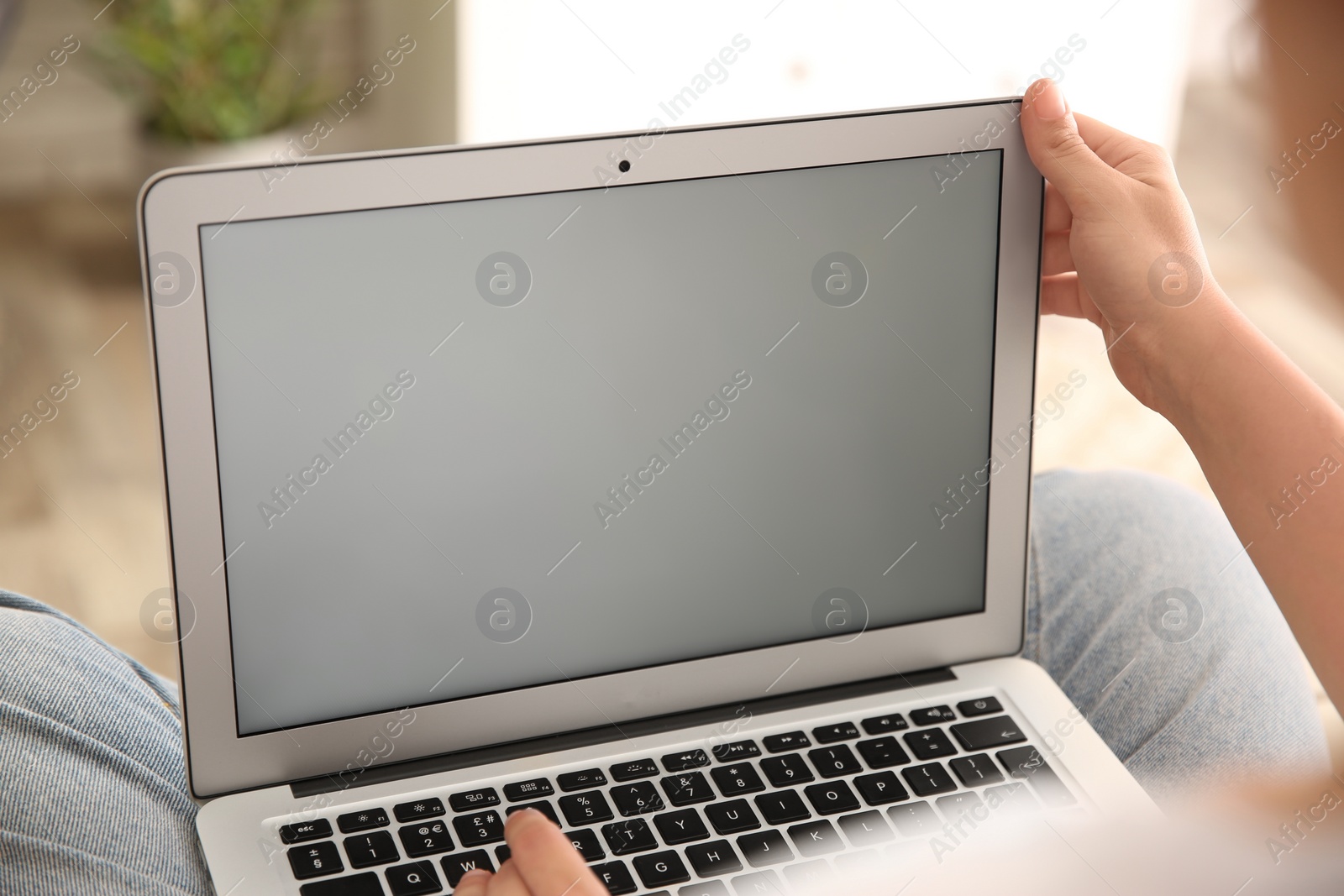 Photo of Woman working with modern laptop indoors, closeup. Space for design