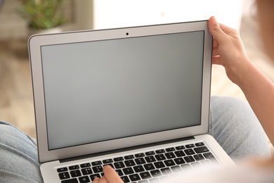 Woman working with modern laptop indoors, closeup. Space for design