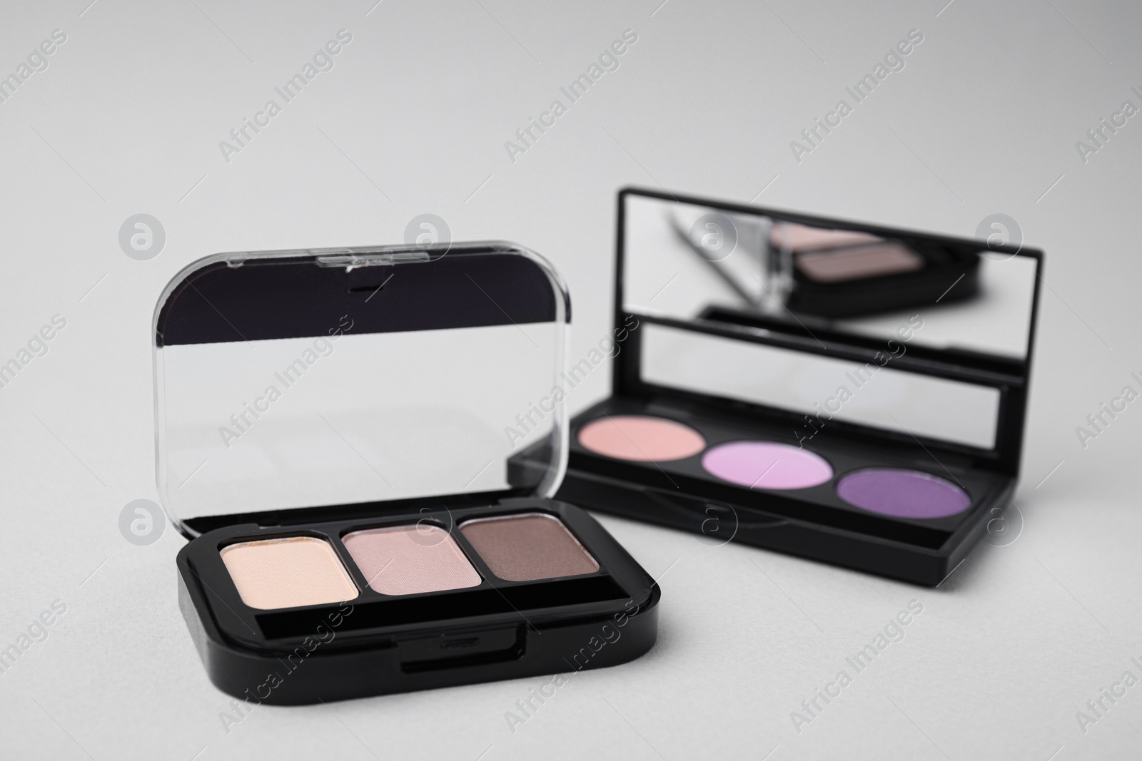 Photo of Beautiful eye shadow palettes on light background