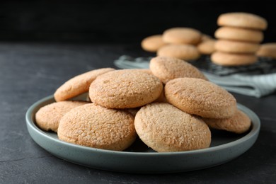 Photo of Delicious sugar cookies on black table, closeup