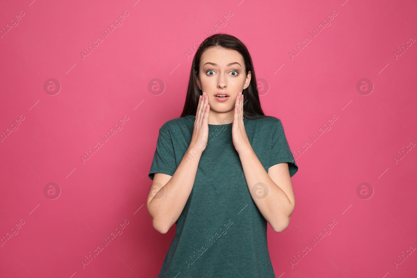 Photo of Portrait of emotional young woman on color background