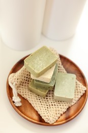 Photo of Soap bars on white table, above view. Spa time
