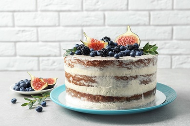 Delicious homemade cake with fresh berries on table