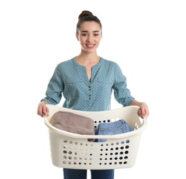 Happy young woman holding basket with laundry on white background