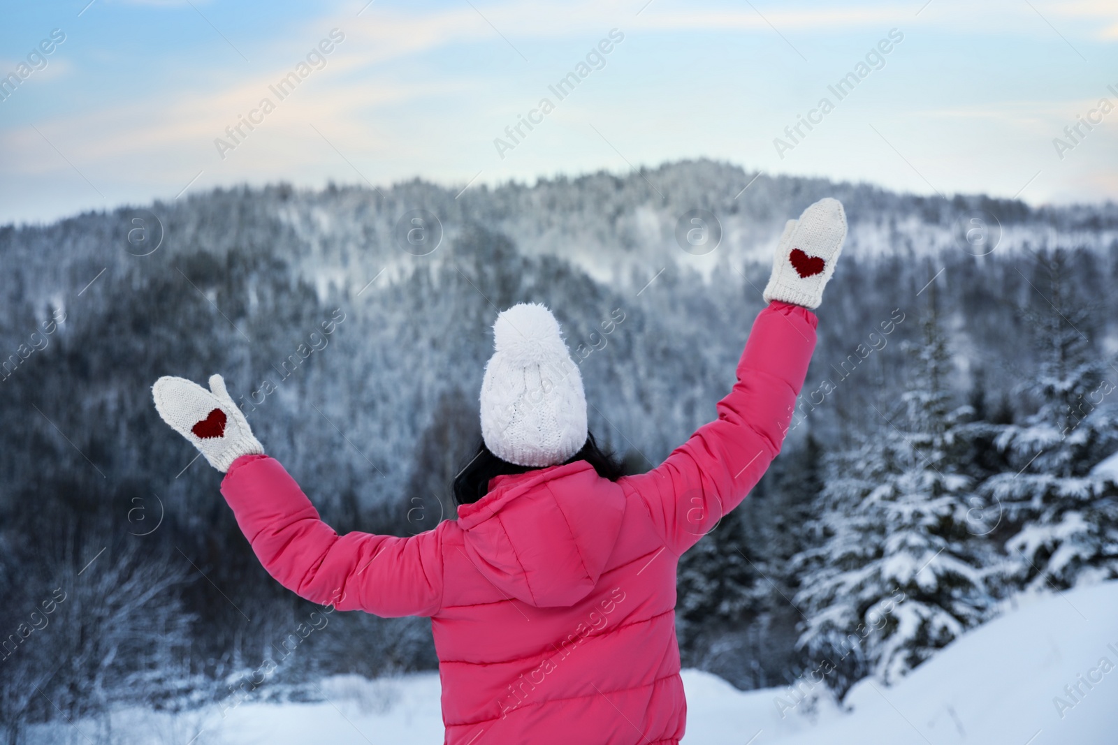 Photo of Woman in pink jacket enjoying trip on snowy day