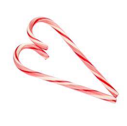Photo of Heart shape made of tasty candy canes on white background. Festive treat