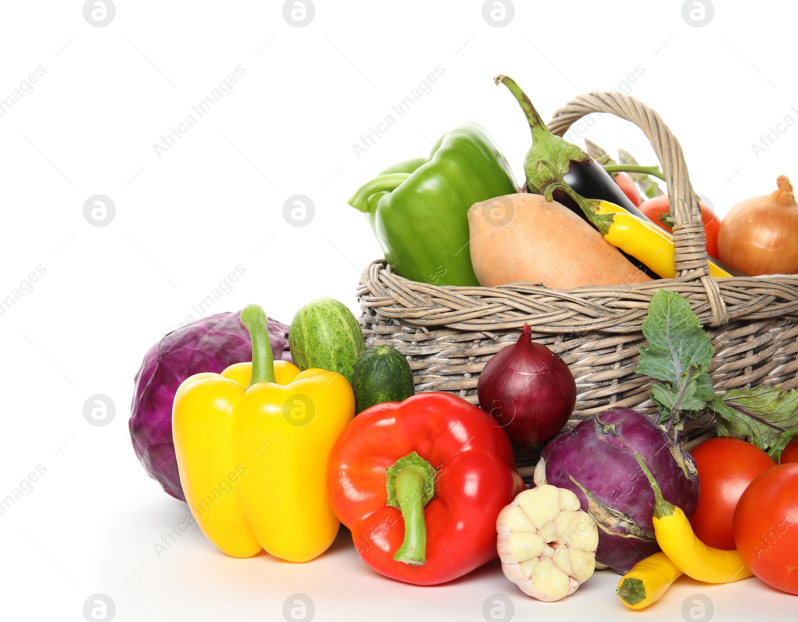 Photo of Many fresh ripe vegetables with basket on white background