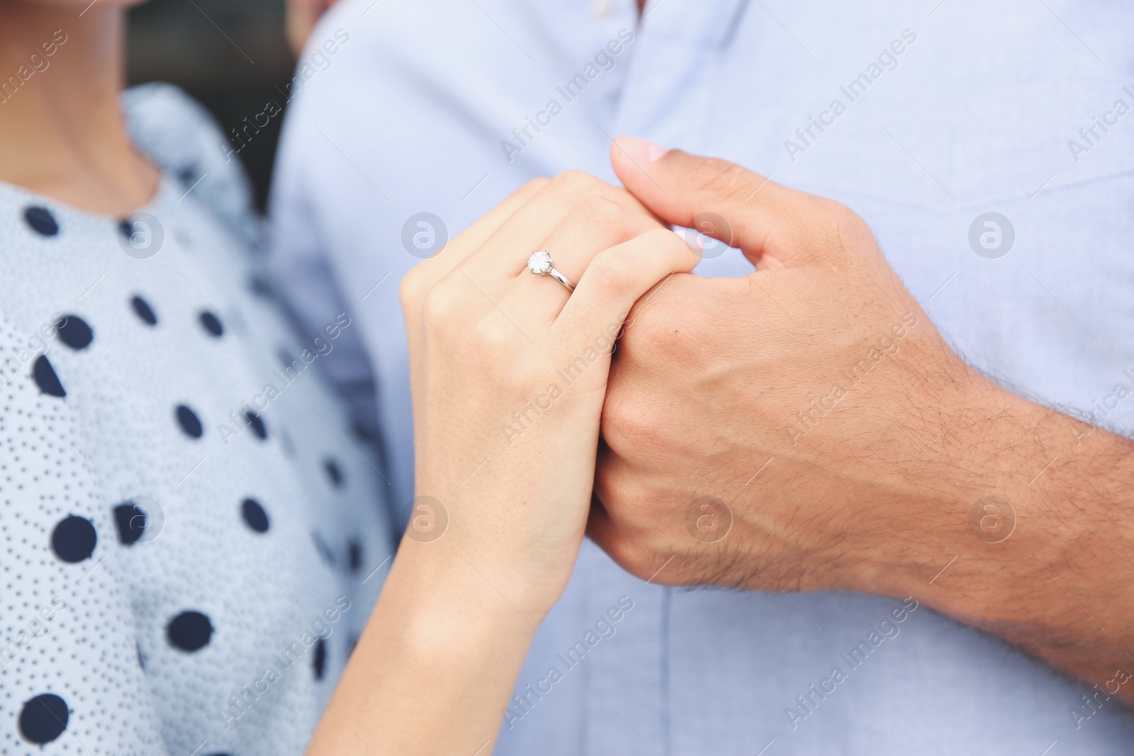Photo of Lovely couple showing beautiful engagement ring, closeup