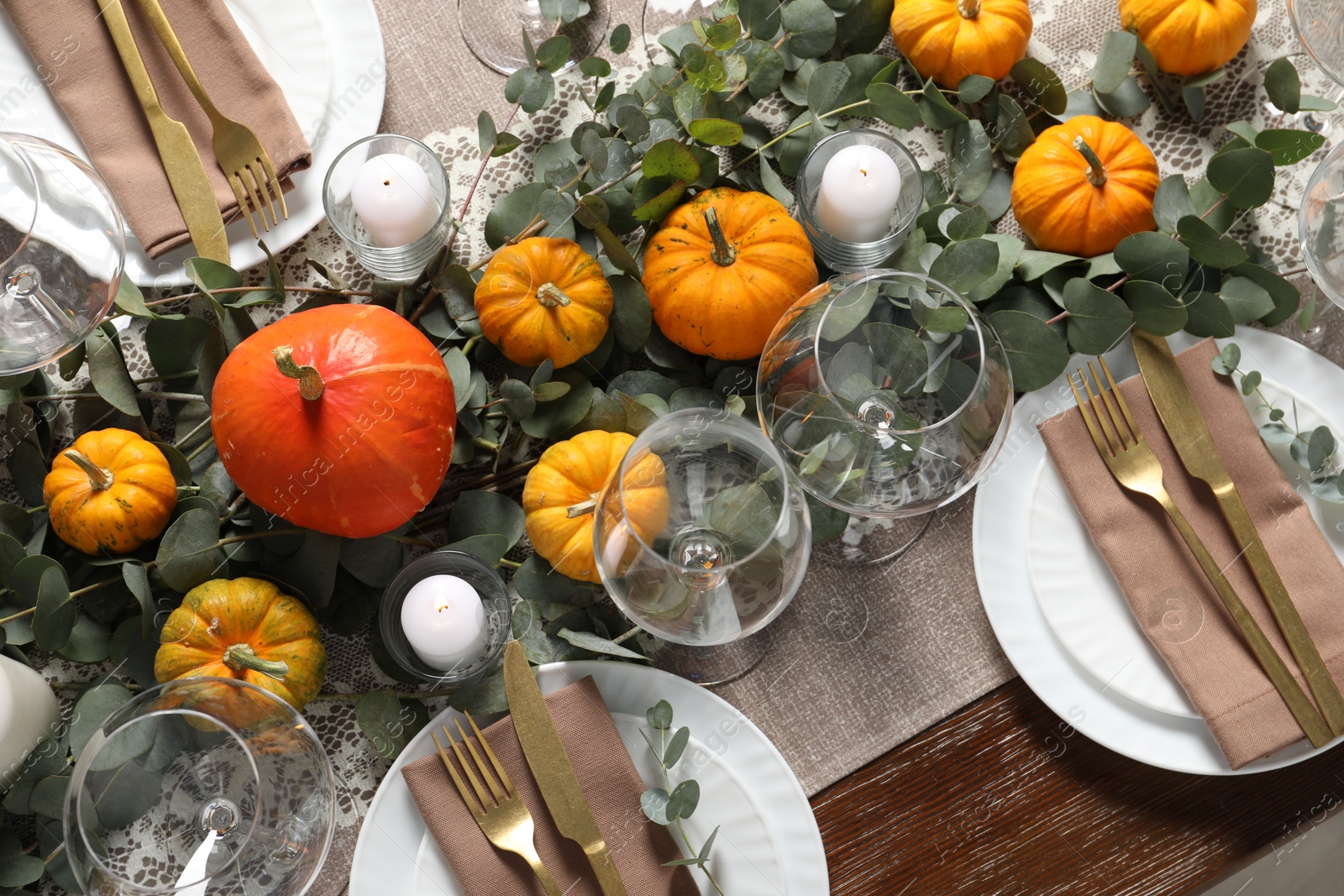Photo of Beautiful autumn table setting. Plates, cutlery, glasses, pumpkins and floral decor, above view