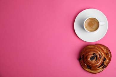 Photo of Delicious coffee and bun on pink background, top view with space for text. Sweet pastries