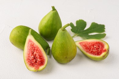 Cut and whole green figs on light table, closeup