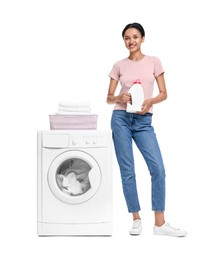 Beautiful woman with detergent near washing machine on white background