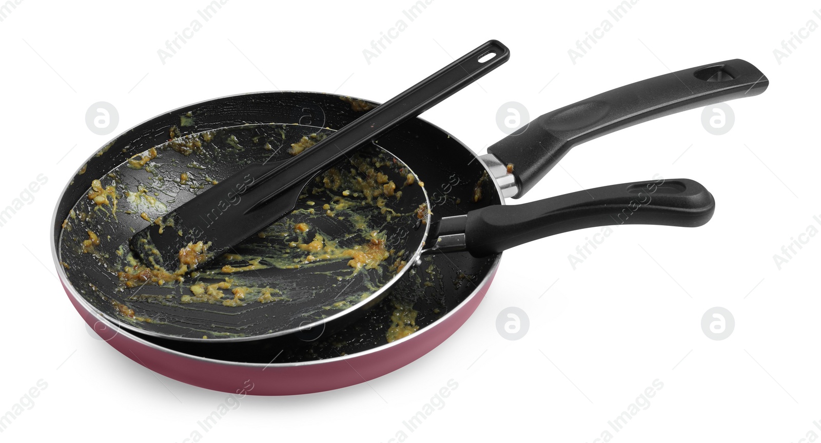 Photo of Dirty frying pans and spatula on white background