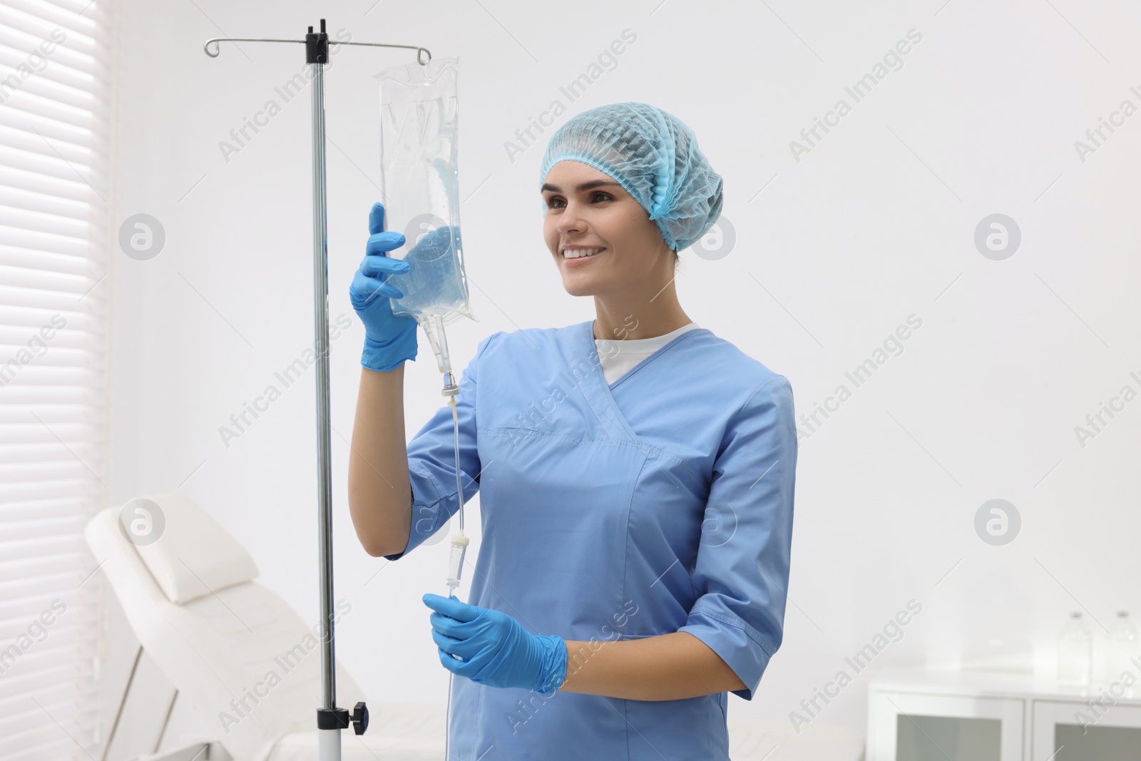 Photo of Nurse setting up IV drip in hospital